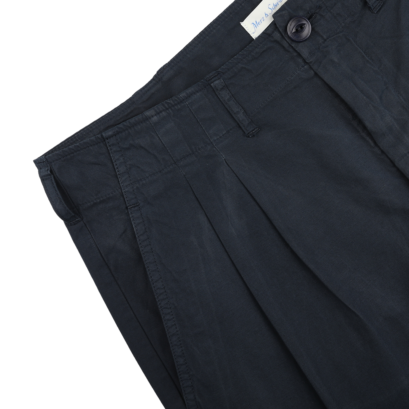 Navy Blue Cotton Poplin 03 Pants by Merz b. Schwanen feature a buttoned waistband and belt loops, offering versatile and comfortable style against a plain backdrop.