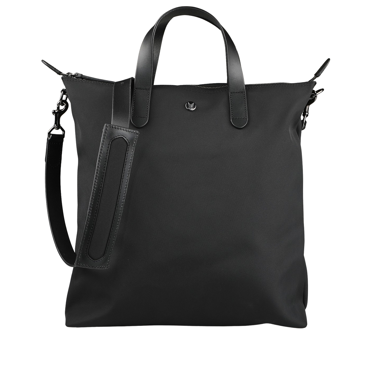 The Eclipse Black M/S Nylon Shopper by Mismo is a black tote bag made from smooth ballistic nylon, with two handles and an adjustable shoulder strap, all set against a neutral background.