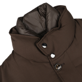 Close-up of the Montecore Brown Super 120s Wool Batavia Padded Coat, showcasing a brown winter design with a high padded collar and visible buttons. The collar lining is made of a shiny, dark material, embodying the elegance typical of Italian outerwear.