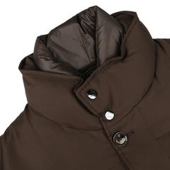 Close-up of the Montecore Brown Super 120s Wool Batavia Padded Coat, showcasing a brown winter design with a high padded collar and visible buttons. The collar lining is made of a shiny, dark material, embodying the elegance typical of Italian outerwear.