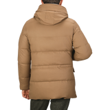 A person is wearing a Camel Beige VBC Wool Flannel Padded Parka with a hood, viewed from the back. This stylish piece, crafted by Montecore, showcases the excellence of Italian outerwear specialists.