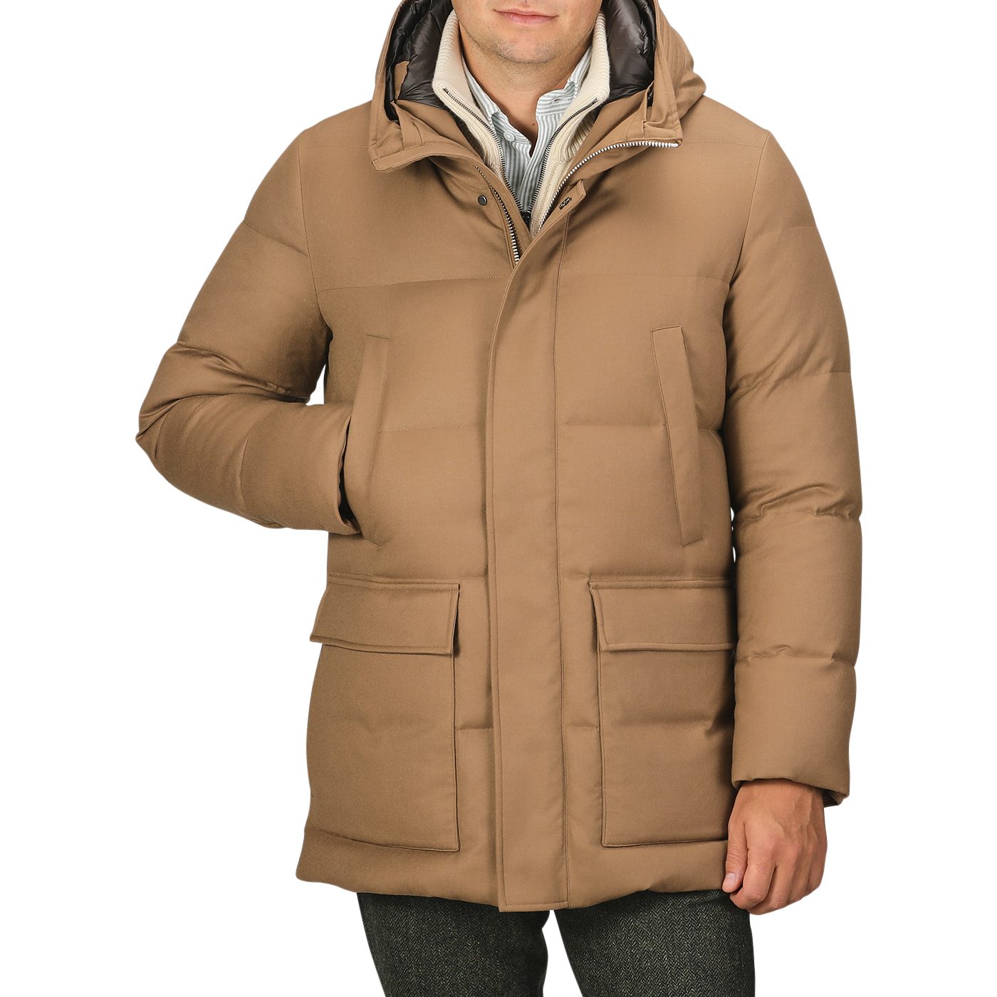 A person wearing the Camel Beige VBC Wool Flannel Padded Parka with a high collar and hood, placing one hand in a front pocket. This stylish piece from Italian outerwear specialist Montecore seamlessly blends functionality with sophistication.