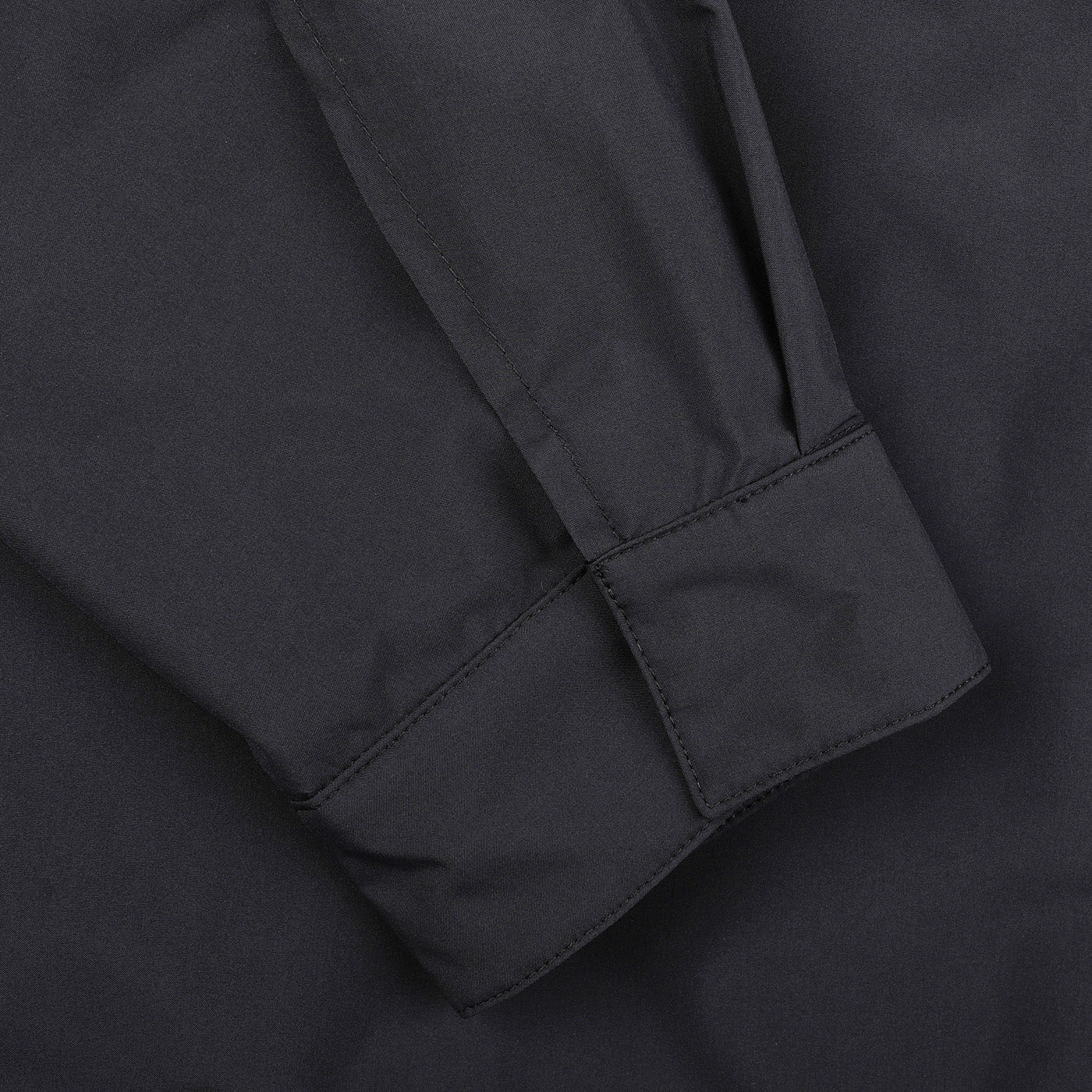 Close-up of a long sleeve with a cuff on the Montecore Dark Blue Light Down Waterproof Shirt Jacket, showcasing the fine stitching and fabric texture by the Italian outerwear specialist.