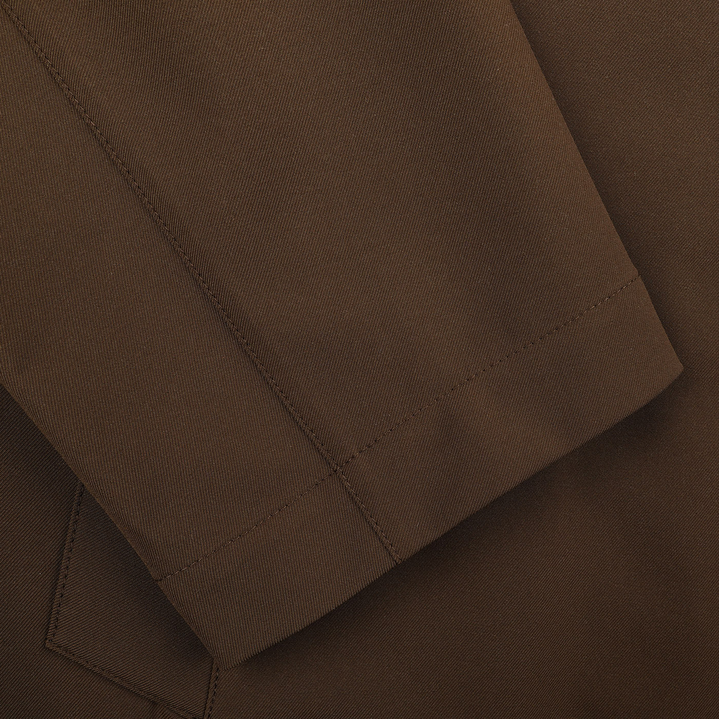 Close-up of the Dark Brown Aéro Twill Car Coat by Montecore, showcasing technical nylon fabric and visible stitching reminiscent of Italian outerwear craftsmanship.