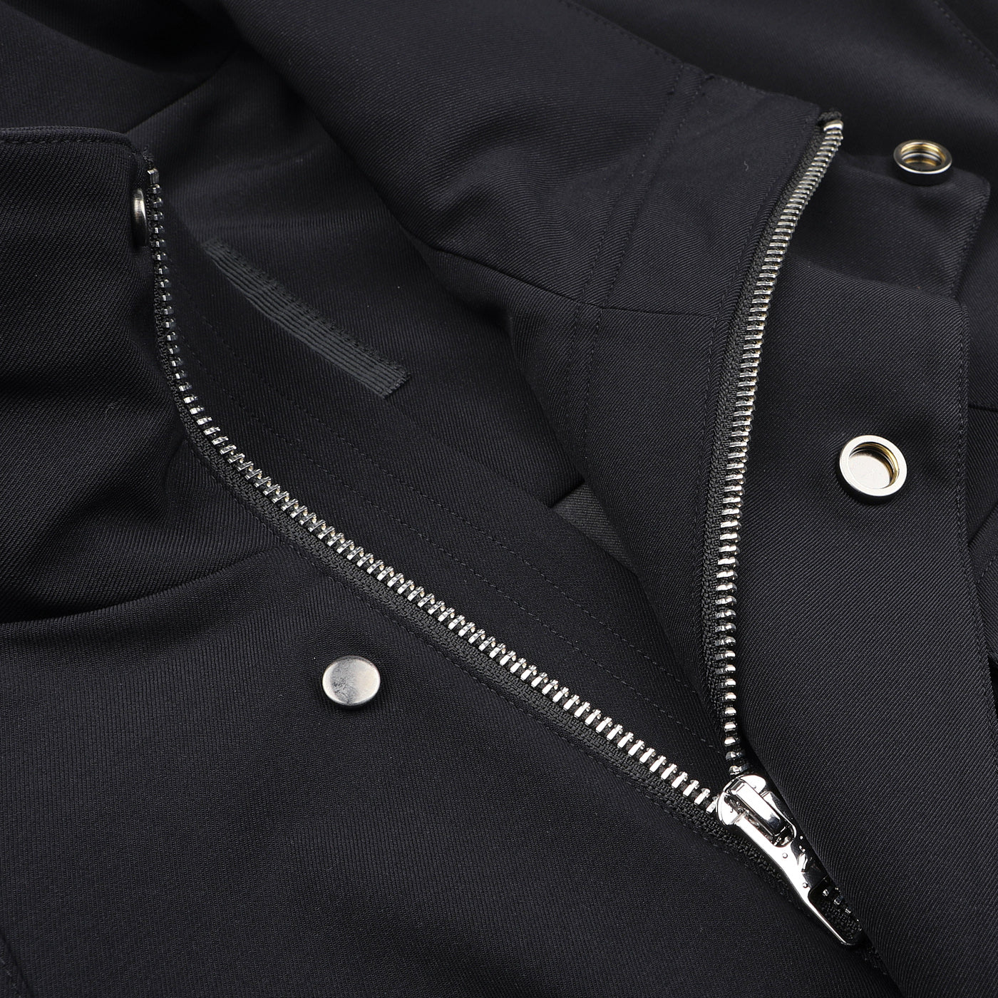 The Montecore Midnight Blue Aéro Twill Field Jacket is a contemporary piece made from sleek technical nylon, with a silver zipper and several metal snaps adorning its surface.