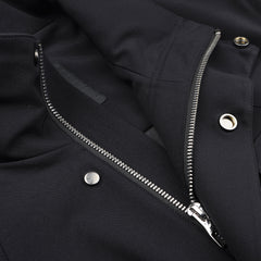 The Montecore Midnight Blue Aéro Twill Field Jacket is a contemporary piece made from sleek technical nylon, with a silver zipper and several metal snaps adorning its surface.