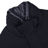 A close-up view of the Montecore Navy Blue Nylon Technical Padded Car Coat, featuring a high padded collar and a zippered closure. The durable technical nylon outer is complemented by an inner lining made of shiny fabric.