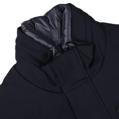 A close-up view of the Montecore Navy Blue Nylon Technical Padded Car Coat, featuring a high padded collar and a zippered closure. The durable technical nylon outer is complemented by an inner lining made of shiny fabric.