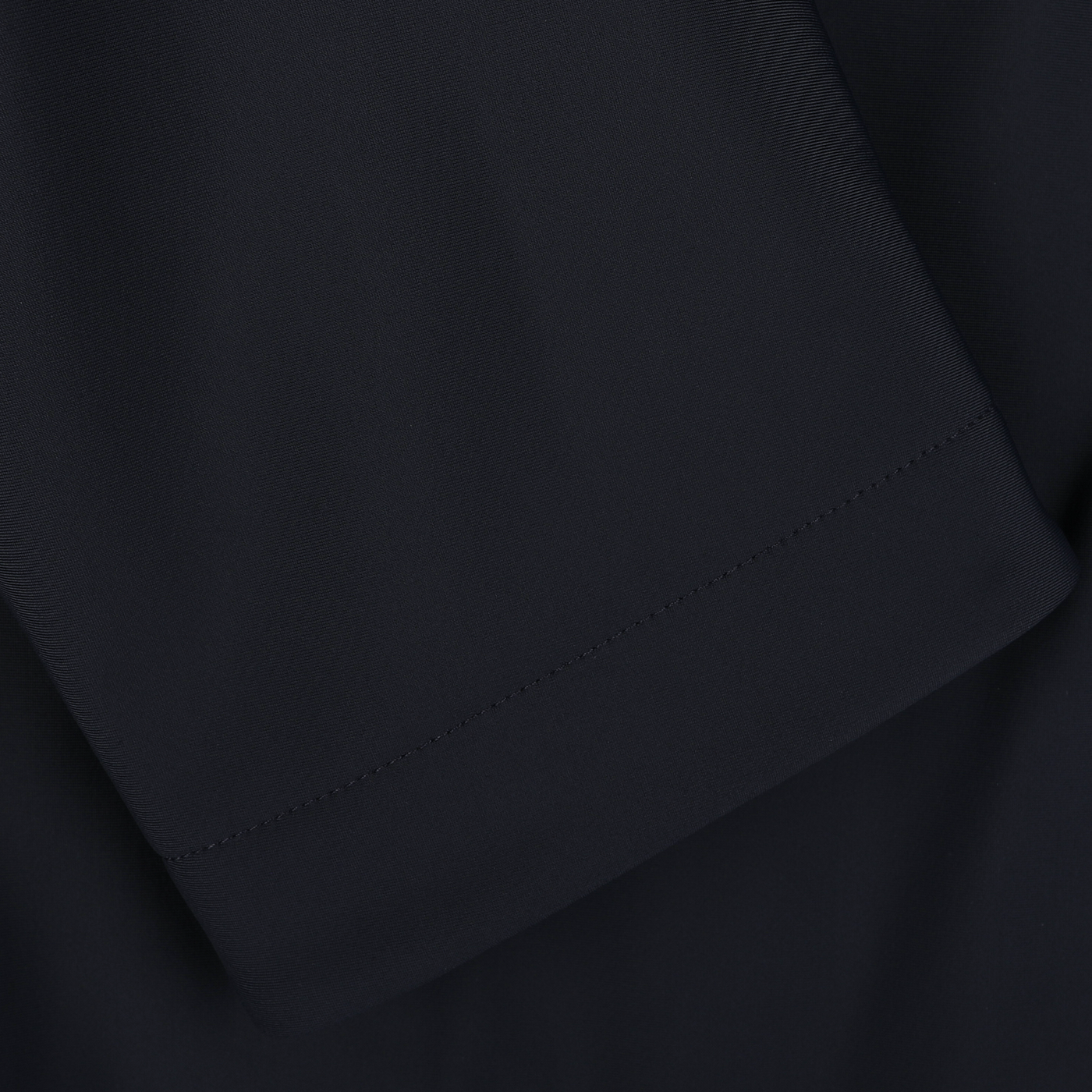 Close-up image of the Navy Blue Nylon Technical Padded Car Coat sleeve seam with visible stitching, showcasing Montecore's expertise.