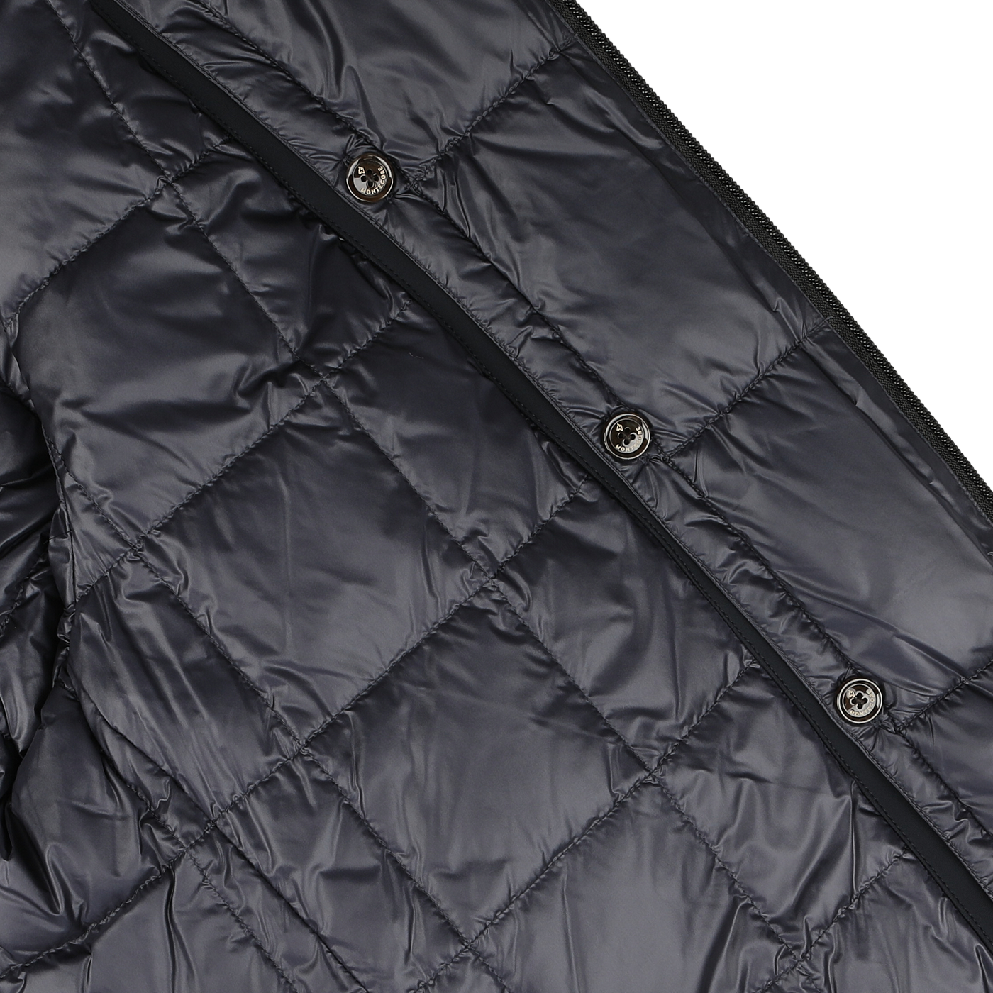 Close-up of a navy blue padded car coat crafted from technical nylon by Montecore, showing button closures and stitching detail.