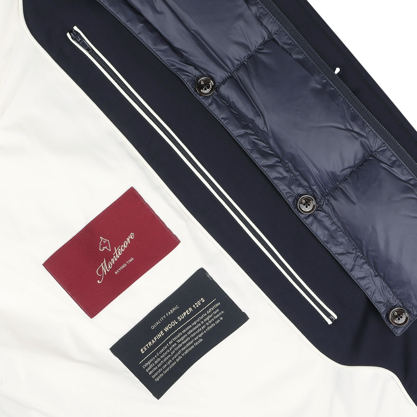 Close-up of a Montecore Navy Blue Super 120s Wool Batavia Padded Coat interior showcasing a maroon brand label, a care label, and contrasting dark and light fabric panels with zippers.