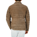 The man is seen from behind wearing a brown Moorer quilted jacket, showcasing Italian outerwear craftsmanship.
