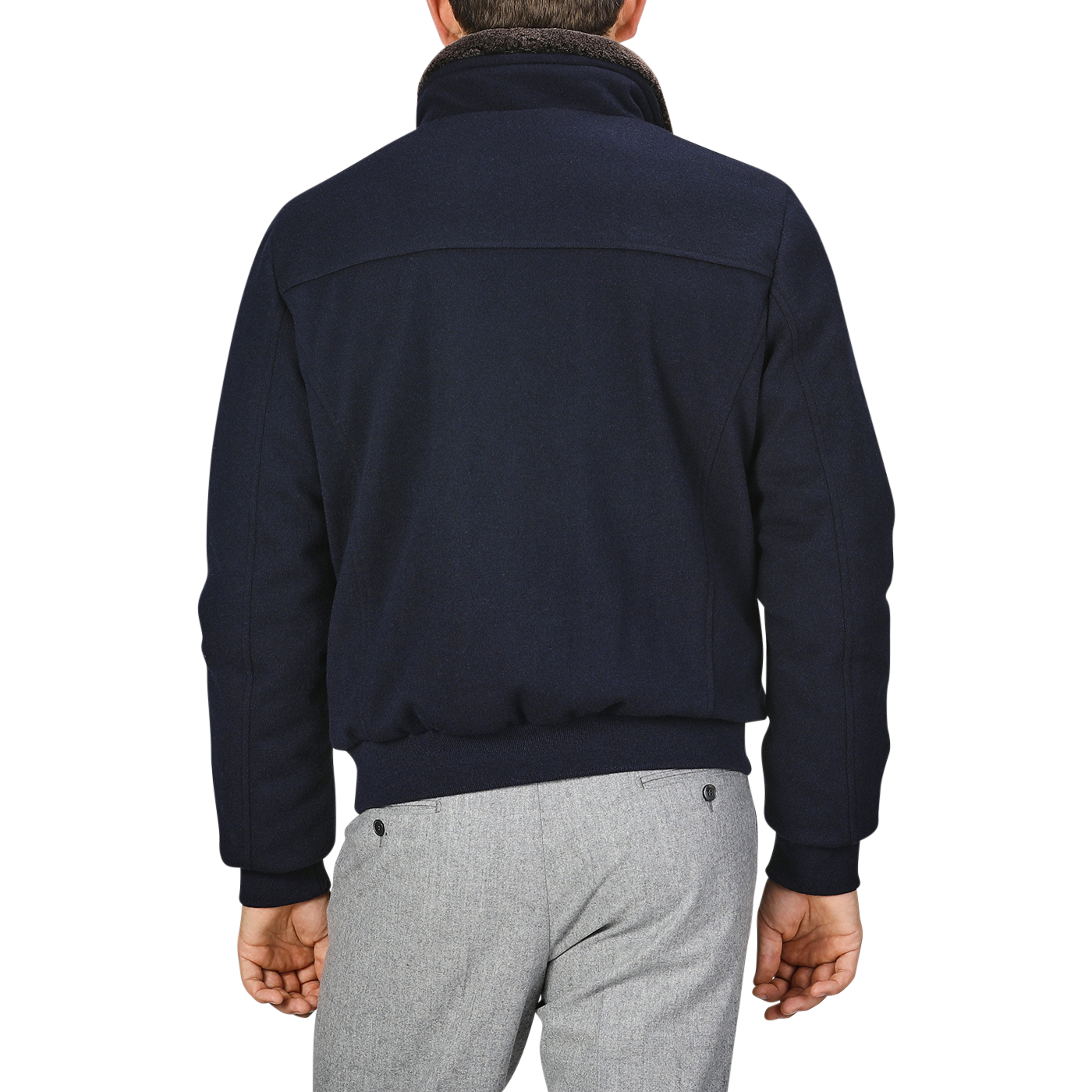 A person is shown from behind, clad in a sleek Navy Blue Cashmere Blend Down Padded Blouson by Moorer and gray pants.