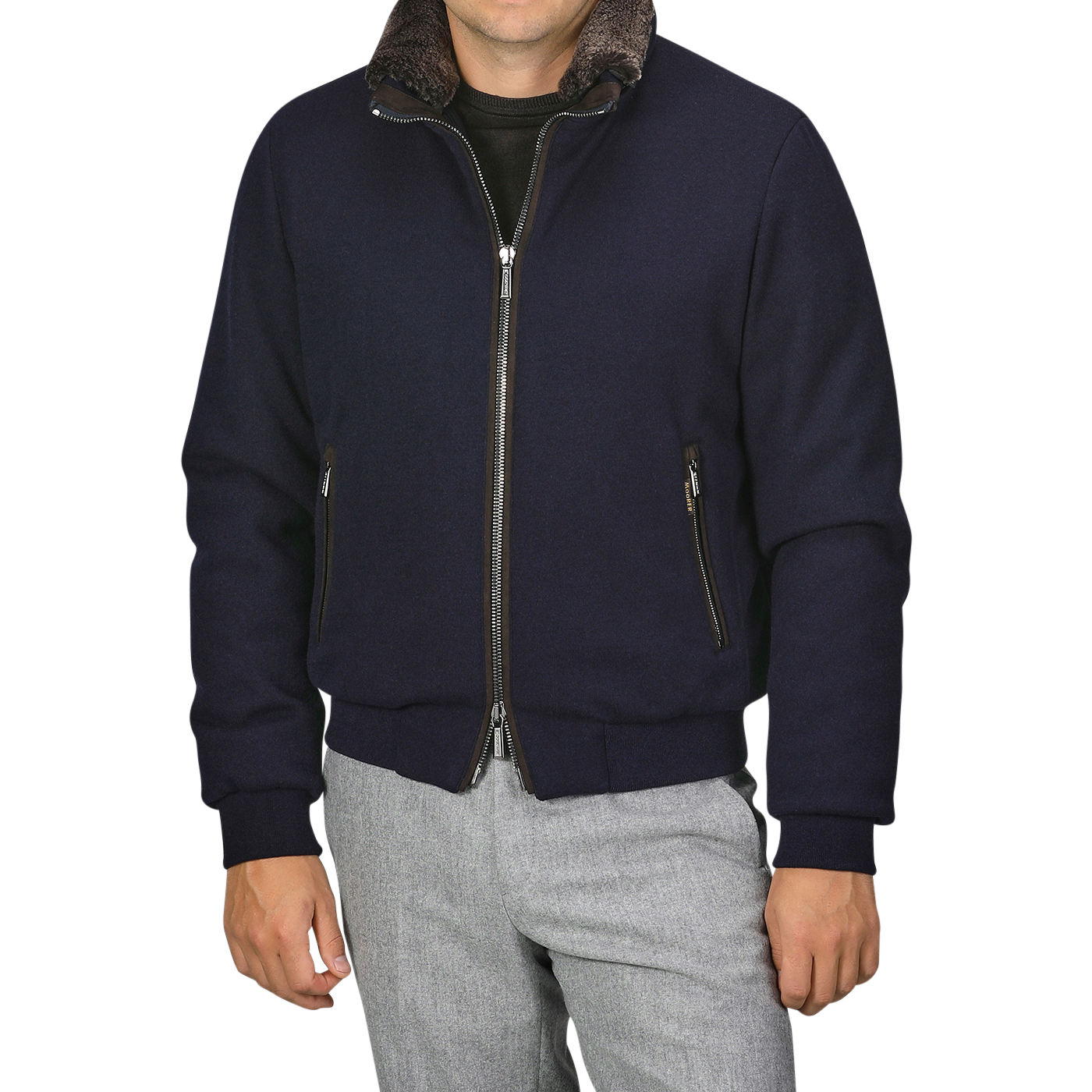 A man wearing a Moorer Navy Blue Cashmere Blend Down Padded Blouson with a brown collar and light gray pants.