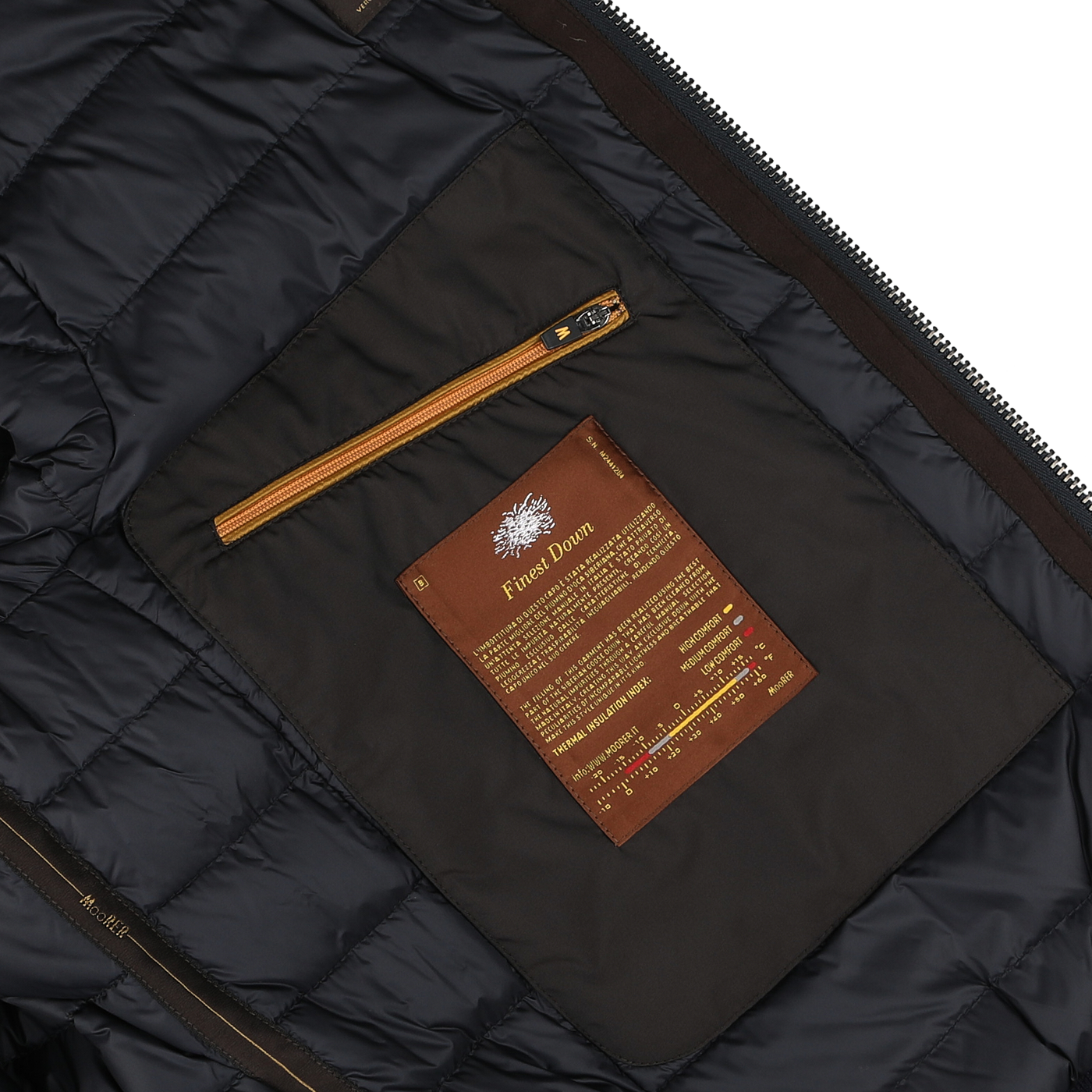 Close-up of the inside of a Moorer Navy Blue Cashmere Blend Down Padded Blouson, showcasing a brown pocket with an orange zipper and a label detailing the blouson's features and care instructions.