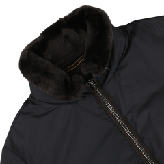 Close-up of the Navy Blue Nylon Down Padded Blouson by Moorer, showcasing a full-length zipper and a soft, black fur-lined collar, crafted from technical nylon.