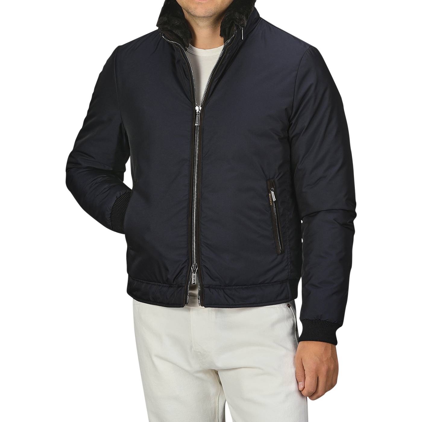 A man wearing the Moorer Navy Blue Nylon Down Padded Blouson with a zippered front and white pants. The jacket, resembling fine Italian outerwear, has a high collar and zippered pockets. The man's head is not visible.