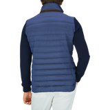 The back view of a man wearing a Moorer Ocean Blue Nylon Knitted Sleeve Jacket.