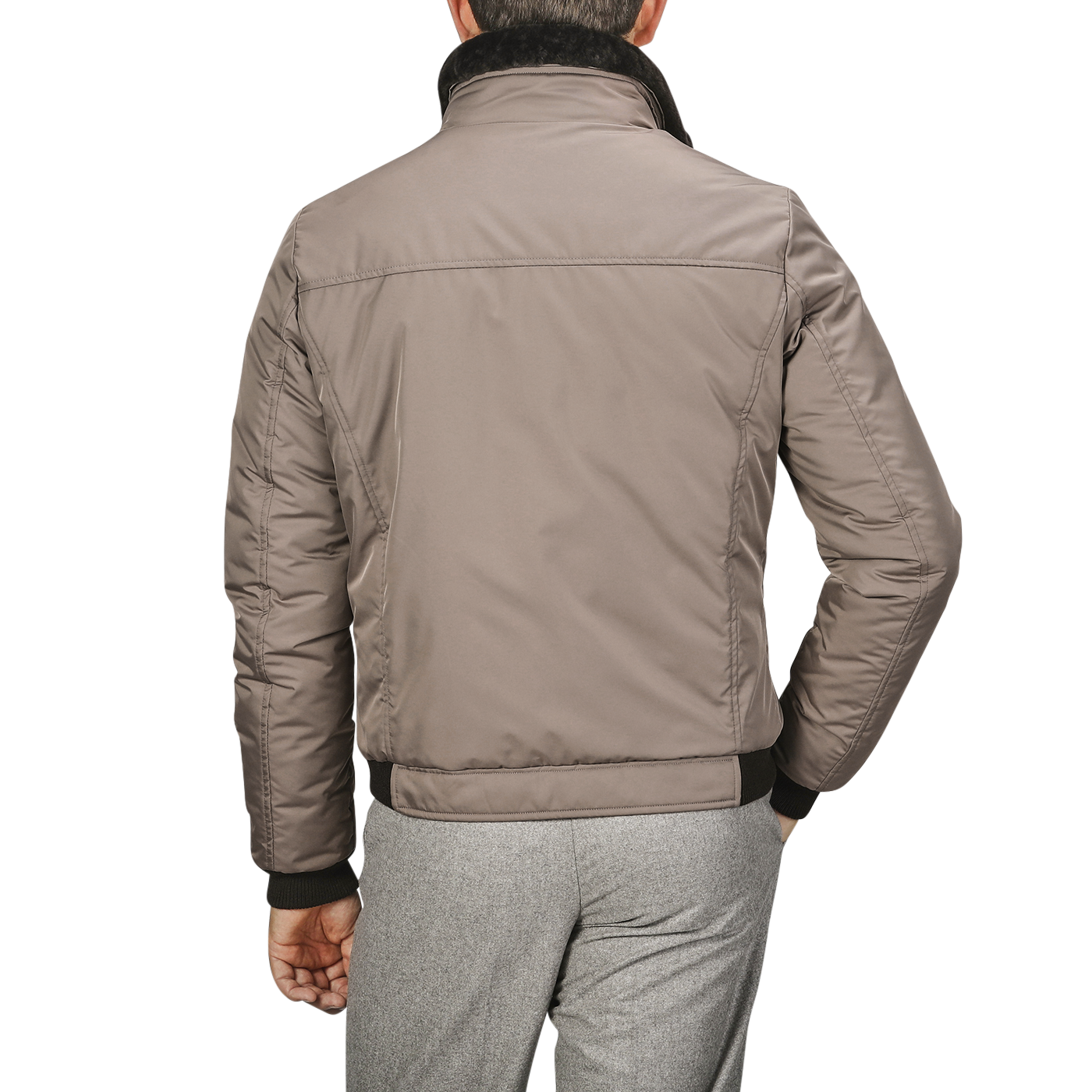 A person wearing a Taupe Beige Nylon Down Padded Blouson by Moorer and light grey pants, showcasing sleek Italian outerwear, is shown from the back.