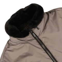 Close-up of the Moorer Taupe Beige Nylon Down Padded Blouson featuring a high, black fur-lined collar and a vertical zipper partially open. Crafted from technical nylon and insulated with goose down for superior warmth and style.