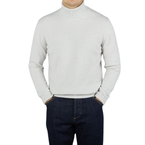 An Morgano Italian knitwear specialist donning a beige grey heavy wool cashmere rollneck sweater.
