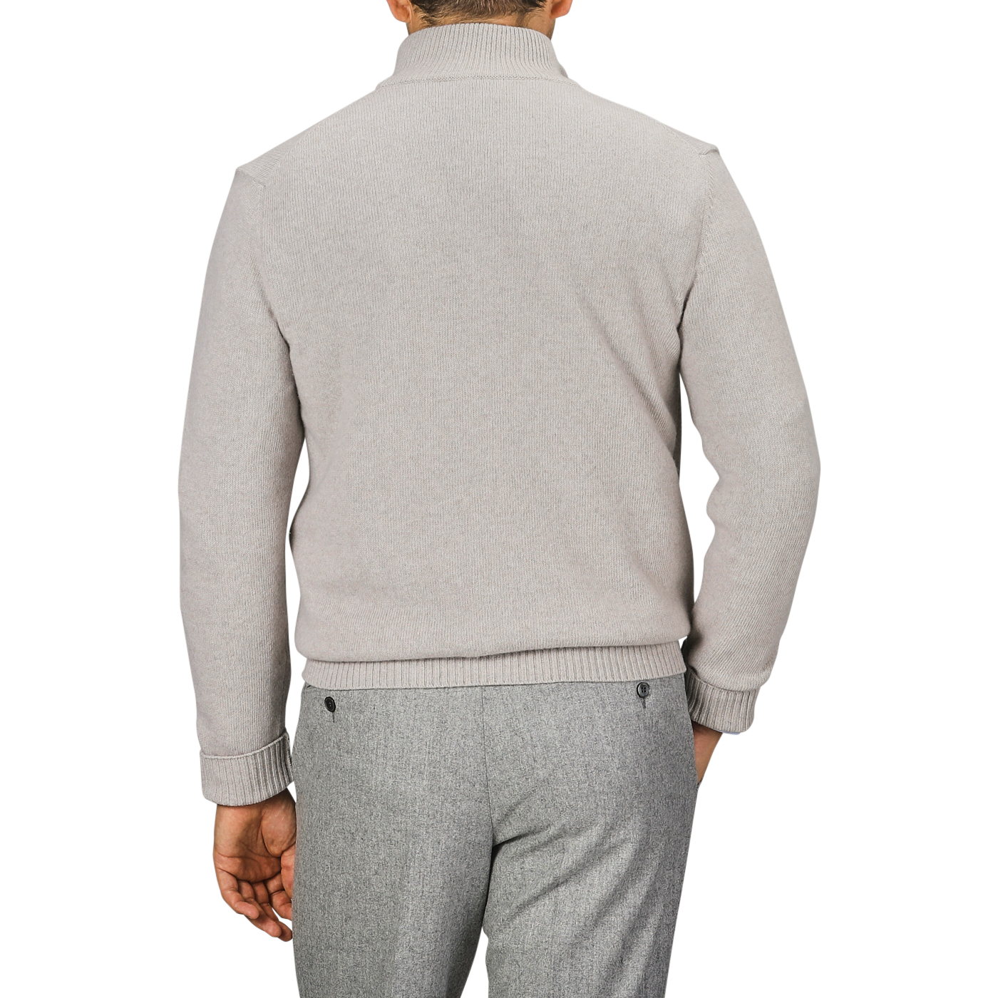 A person is seen from the back wearing a light taupe beige Morgano wool cashmere quarter-zip and gray pants.