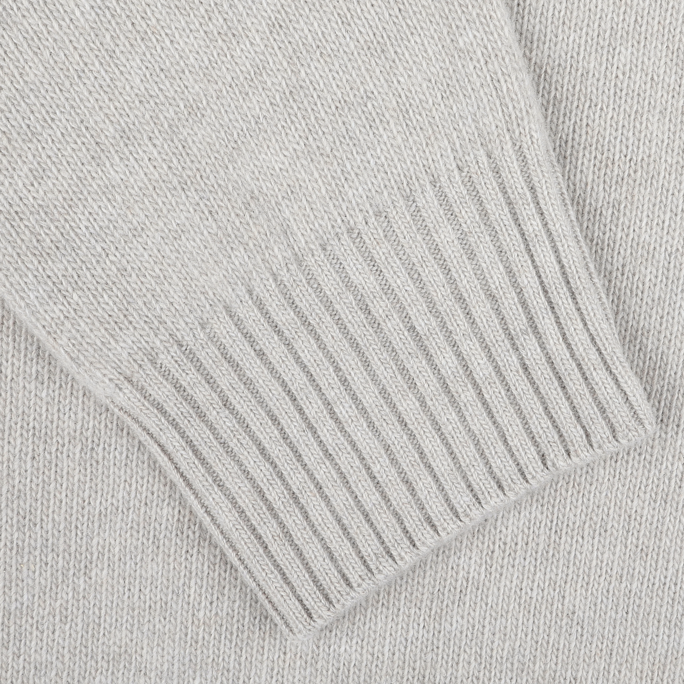 Close-up view of the ribbed cuff of a taupe beige wool cashmere quarter zip by Morgano, crafted from luxurious merino wool and cashmere by an Italian knitwear specialist.