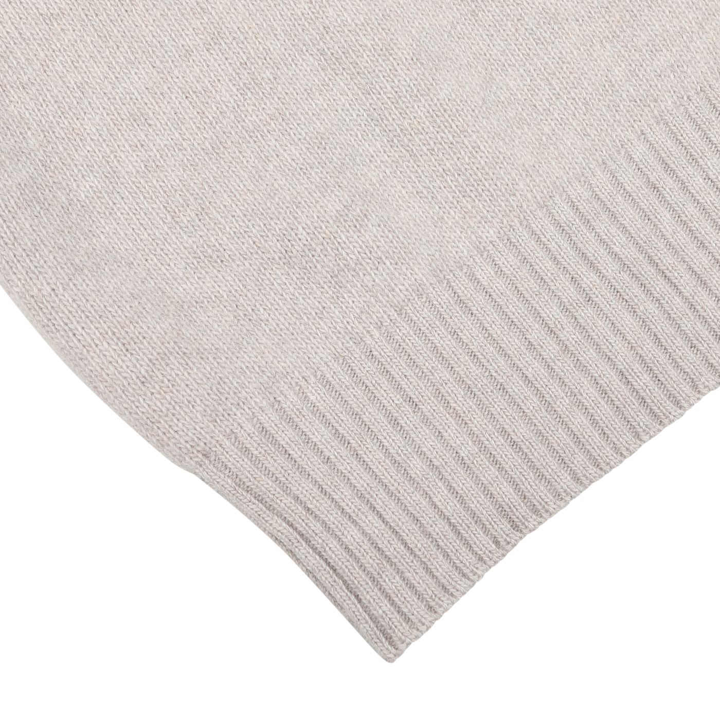 Close-up of the corner of a Taupe Beige Wool Cashmere Quarter Zip from Morgano, showcasing the texture and ribbed hem pattern crafted by an Italian knitwear specialist.