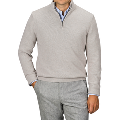 Man wearing a Taupe Beige Wool Cashmere Quarter Zip sweater by Morgano over a blue collared shirt, paired with gray trousers, standing against a neutral background.