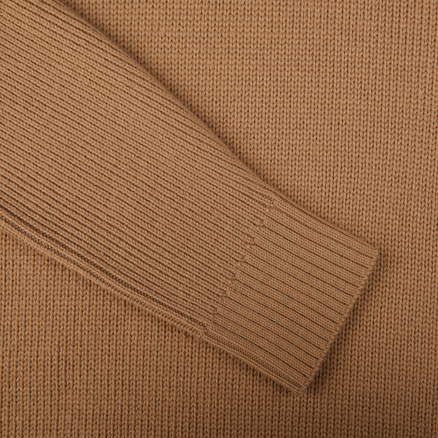 A close up of a Morgano camel beige heavy merino wool rollneck sweater, showcasing its exquisite Italian knitwear.