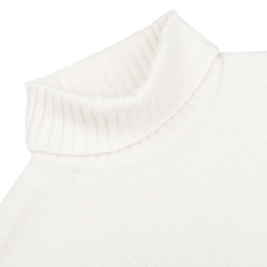 Close-up of a Cream Heavy Wool Cashmere Rollneck by Morgano on a plain background, showcasing its luxurious material.