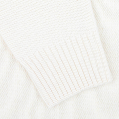 Close-up of the Cream Heavy Wool Cashmere Rollneck by Morgano, highlighting its white knitted fabric with a ribbed cuff that showcases a luxurious blend of cashmere for ultimate comfort.