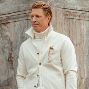 A man wearing a Morgano Cream Heavy Wool Cashmere Rollneck turtleneck sweater.