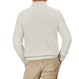 A person is shown from the back wearing a Morgano Cream Wool Cashmere Quarter Zip and beige pants against a neutral background.