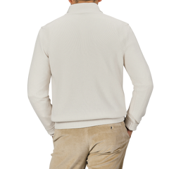 A person is shown from the back wearing a Morgano Cream Wool Cashmere Quarter Zip and beige pants against a neutral background.