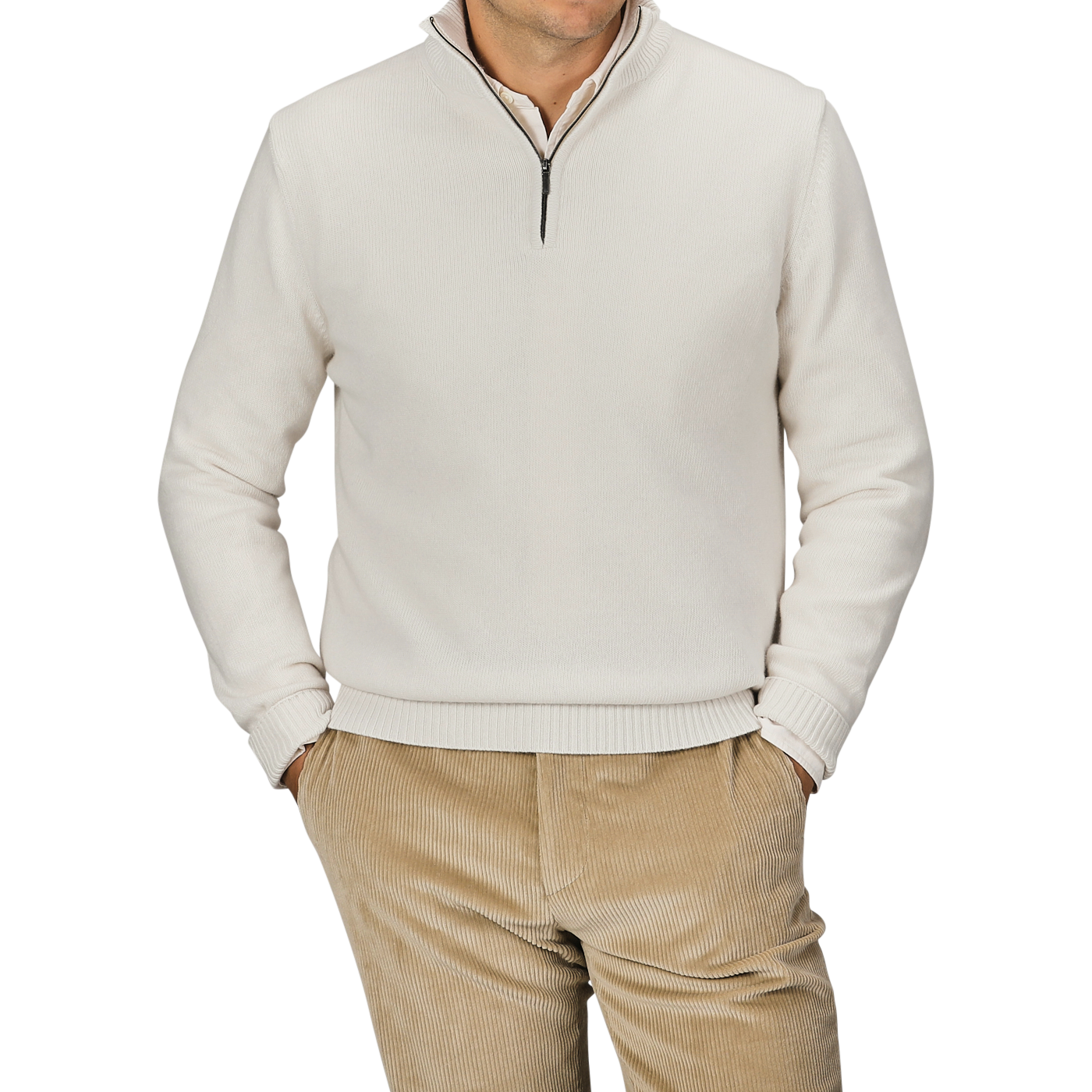 A person wearing a Cream Wool Cashmere Quarter Zip by Morgano and beige corduroy pants stands with hands in pockets against a plain background.