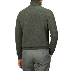 A person wearing a Green Melange Heavy Wool Cashmere Rollneck by Morgano and gray pants is shown from behind, against a plain background.