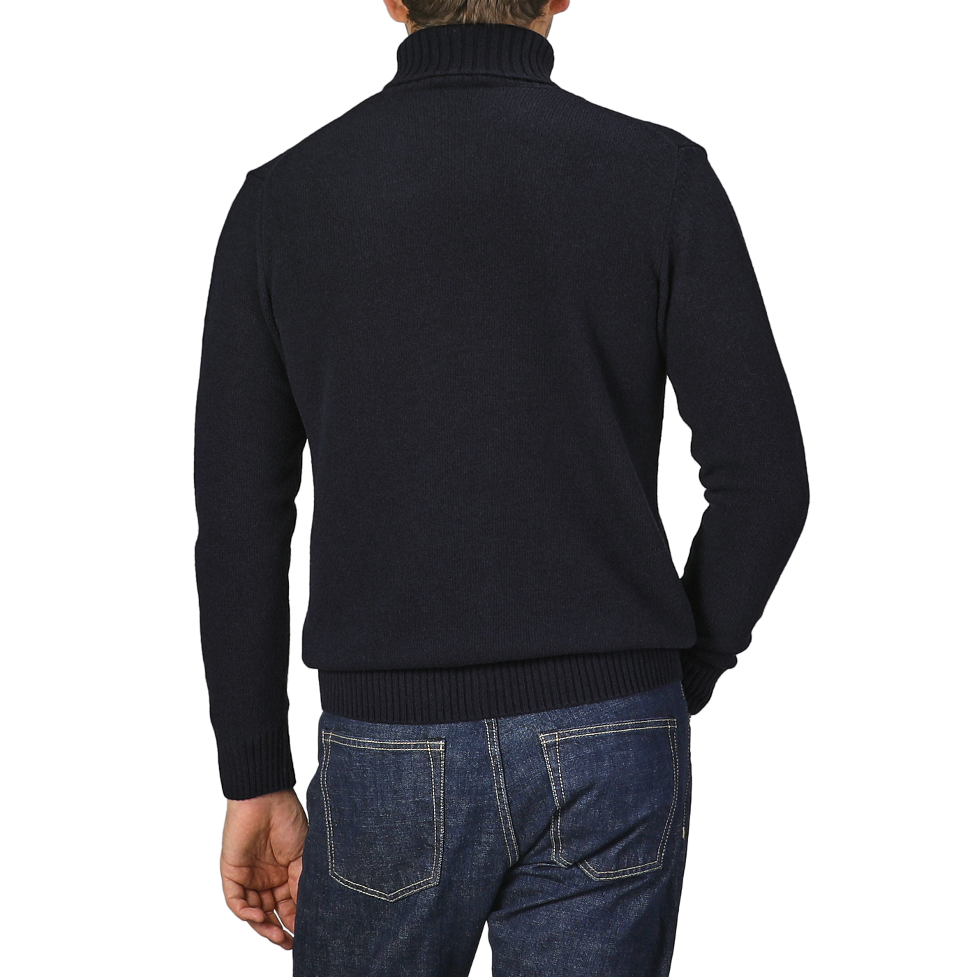 A person wearing a Morgano Navy Blue Heavy Wool Cashmere Rollneck sweater and blue jeans, standing with their back facing the camera.