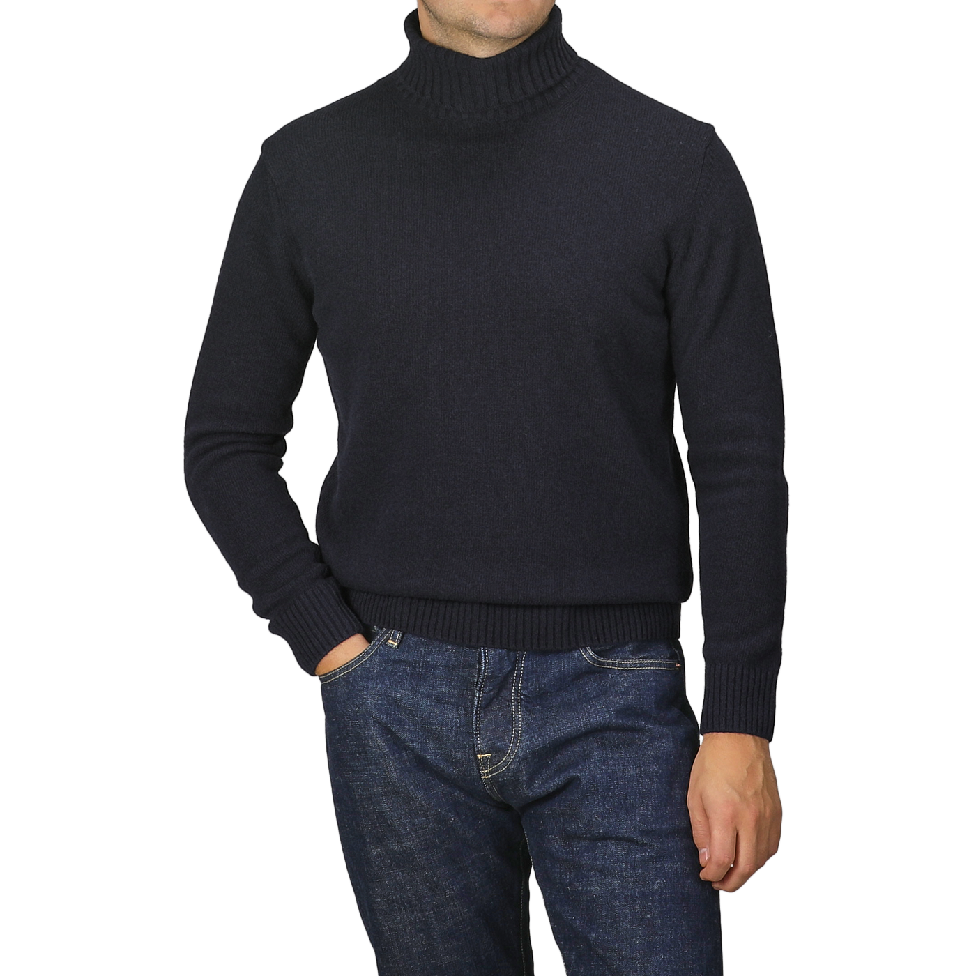 A person wearing a Morgano Navy Blue Heavy Wool Cashmere Rollneck and blue jeans stands with one hand in a pocket.