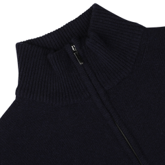 Close-up of the Navy Blue Wool Cashmere Quarter Zip by Morgano, showcasing a neatly folded top. The dark blue merino wool and cashmere blend ensures comfort and luxury, crafted meticulously by an Italian knitwear specialist.