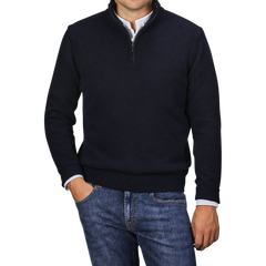 A person is wearing the Morgano Navy Blue Wool Cashmere Quarter Zip over a white collared shirt and blue jeans, standing with one hand in their pocket.