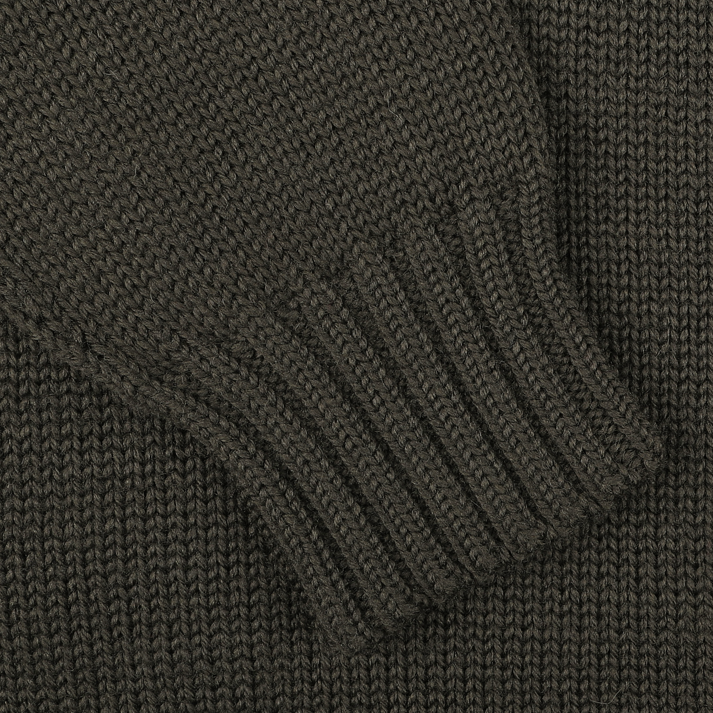 Close-up of a khaki green merino wool Garbis sweater sleeve with ribbed cuff detail by Nitto.