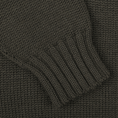 Close-up of a khaki green merino wool Garbis sweater sleeve with ribbed cuff detail by Nitto.