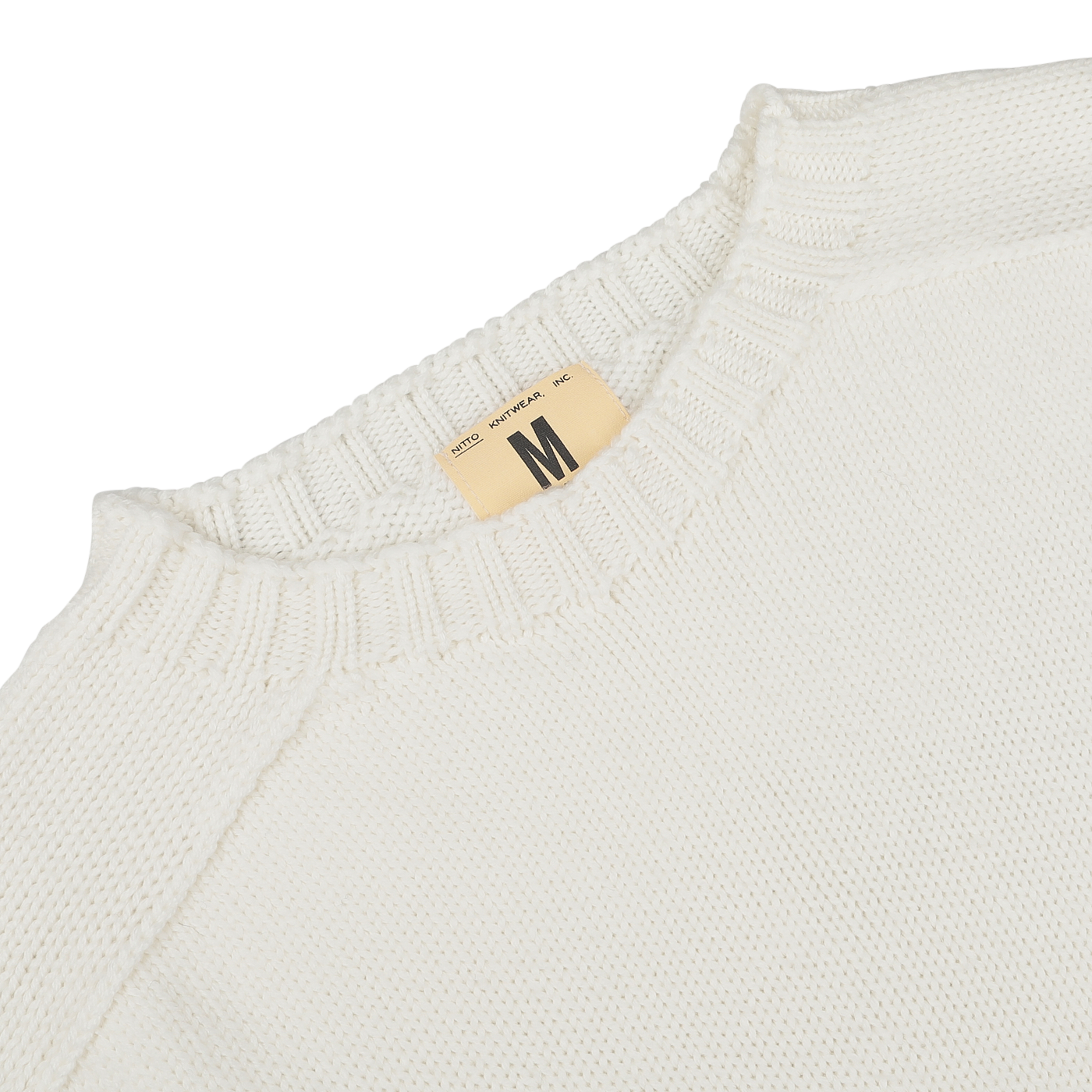 A close-up of an Ecru White Merino Wool Garbis Sweater from Nitto features a ribbed neckline and a size label marked "Medium.