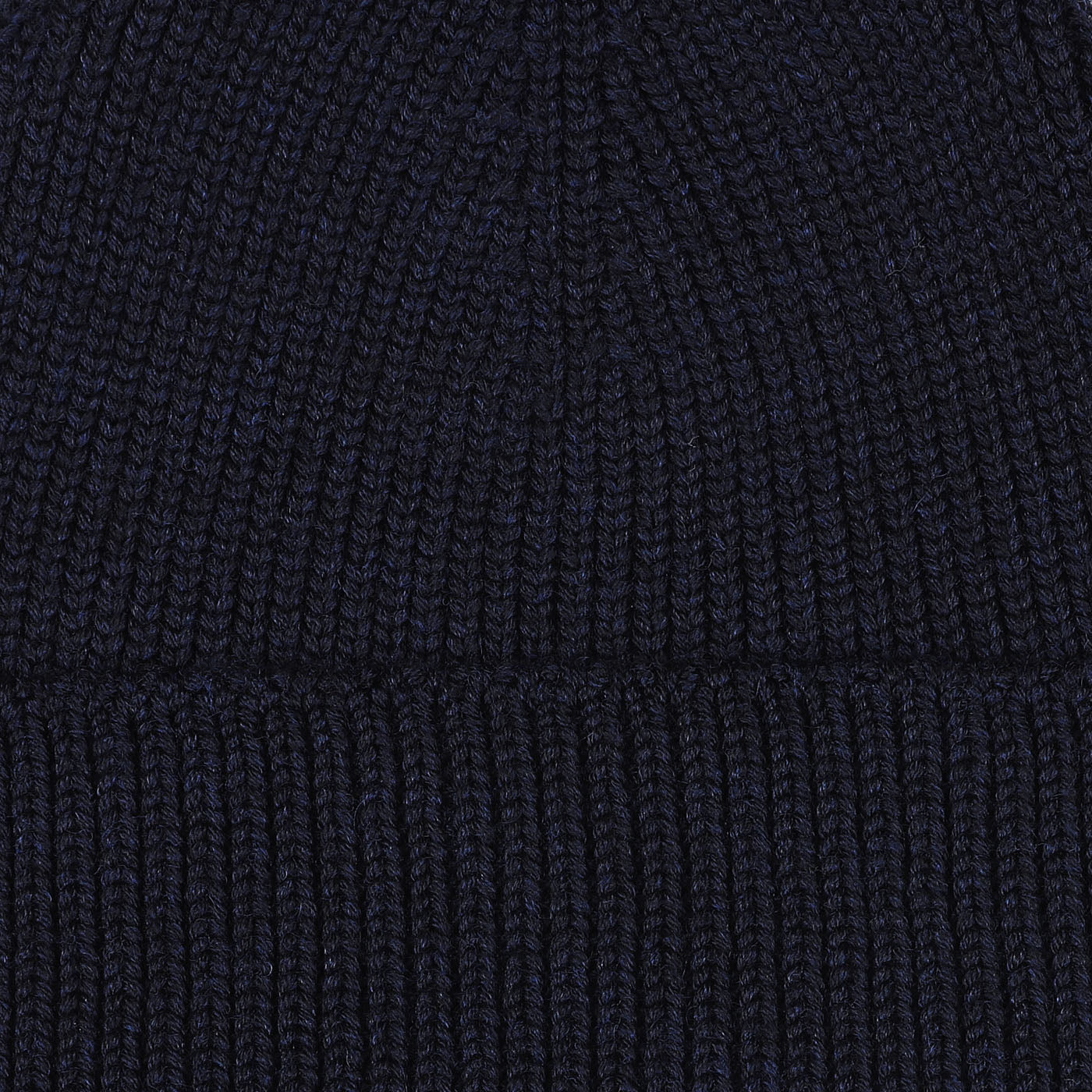 Close-up image of a Marine Blue Merino Wool Ara Beanie, crafted by Nitto.