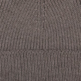 Close-up of a Taupe Grey Merino Wool Ara Beanie, showcasing the texture and stitching pattern crafted by Nitto.