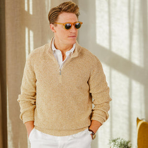 A man wearing a Gran Sasso Oat Beige Rib Stitch Cotton 1/4 Zip Sweater, a perfect layering piece in oat beige melange color, paired with white pants.