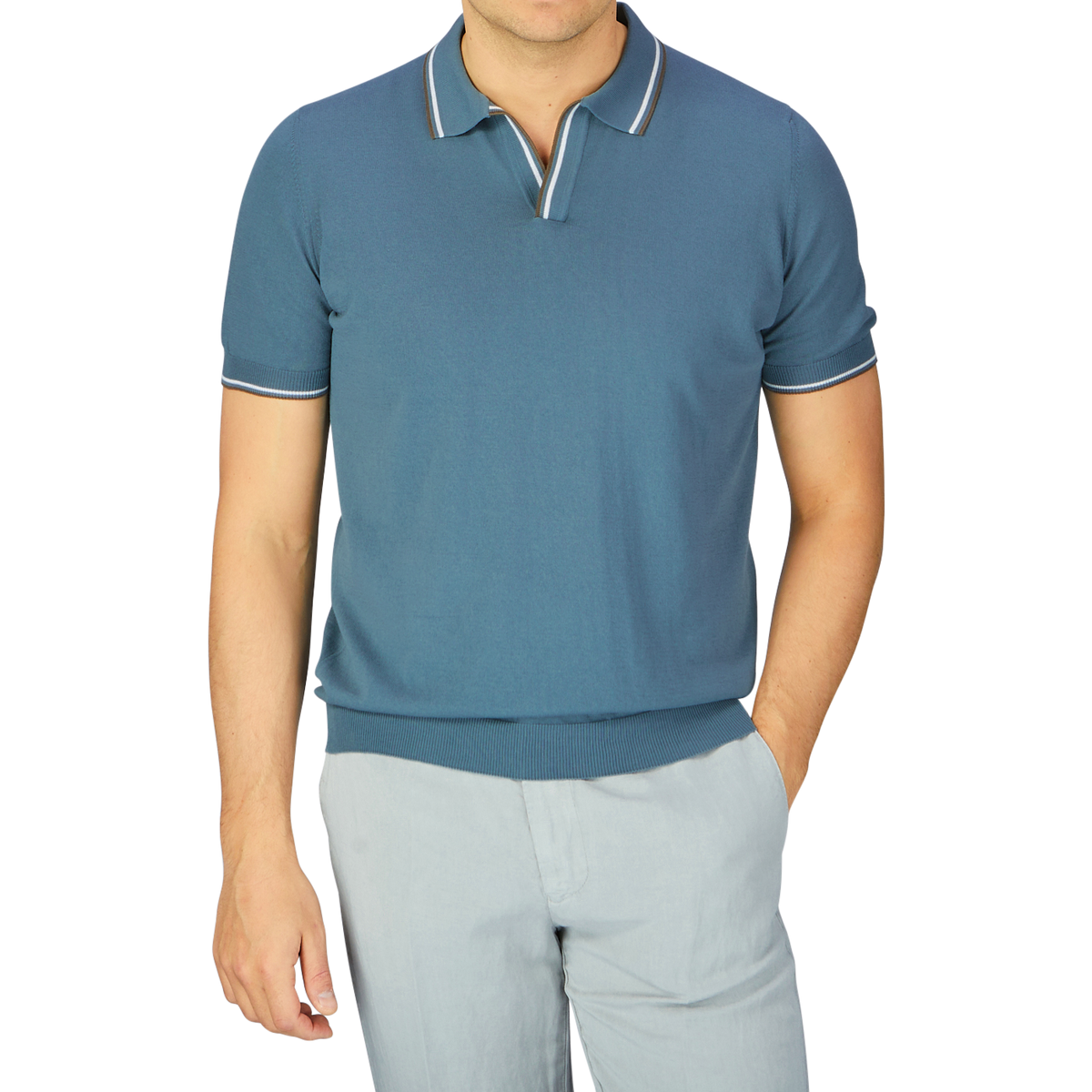A man dressed in a Gran Sasso Ocean Blue Fresh Cotton Polo Shirt with a Capri collar and light gray trousers.
