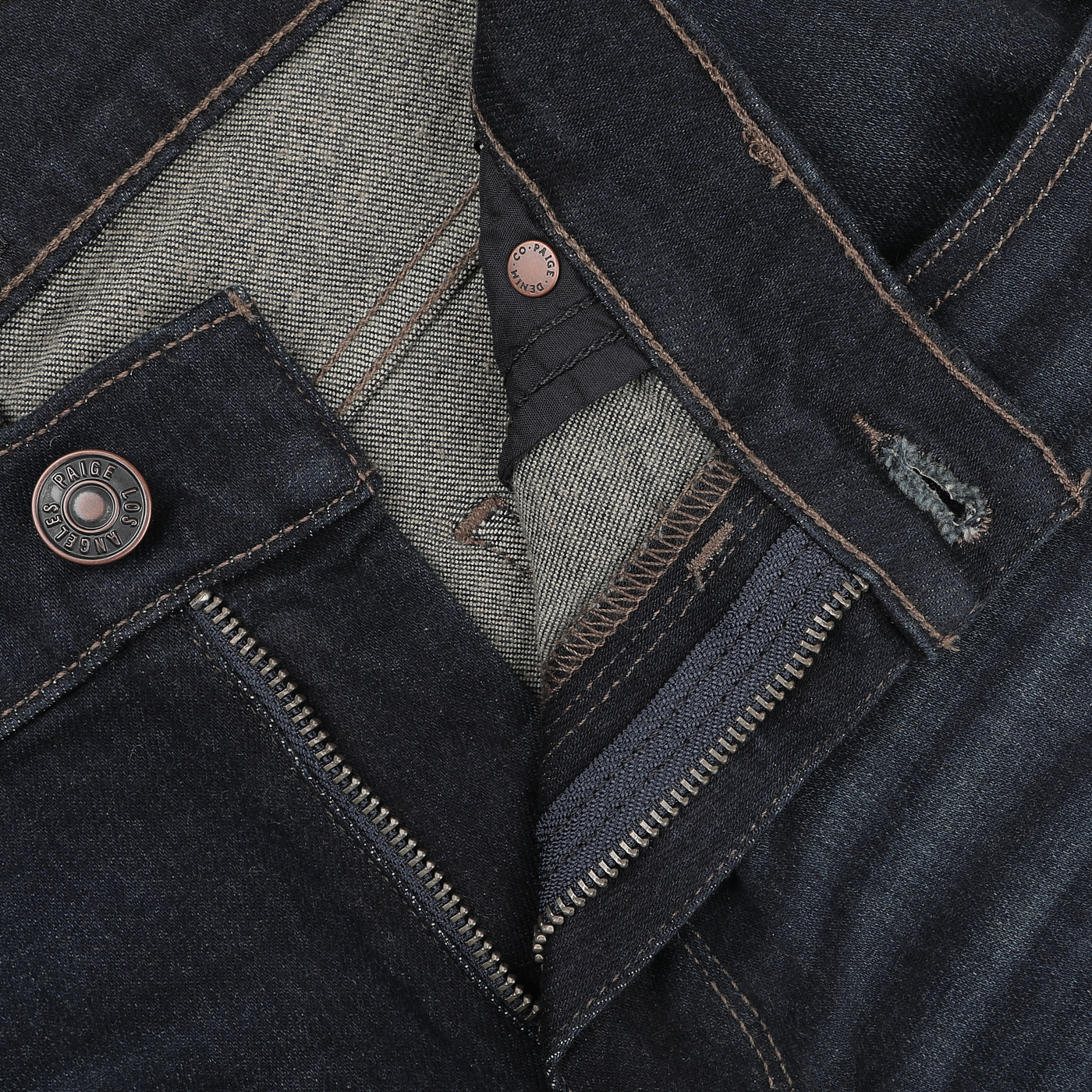 Close-up of the Paige Blue Faded Cotton Cramer Normandie Jeans with a straight leg design, featuring a metal button and partially open zipper that reveals the interior fabric lining and stitching details.