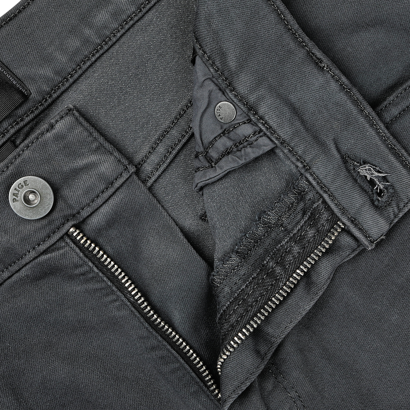 Close-up view of a partially unzipped pair of Charcoal Cotton Transcend Federal Slim Jeans by Paige, revealing intricate stitching and button details, crafted from Transcend fabric for a comfortable fit.